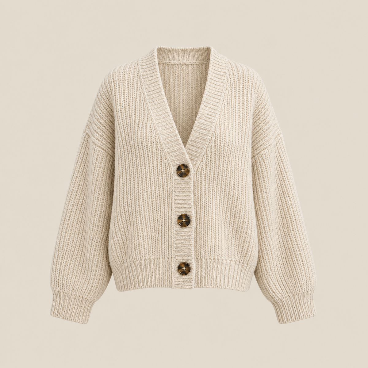 Ivory knit cardigan on a warm beige background